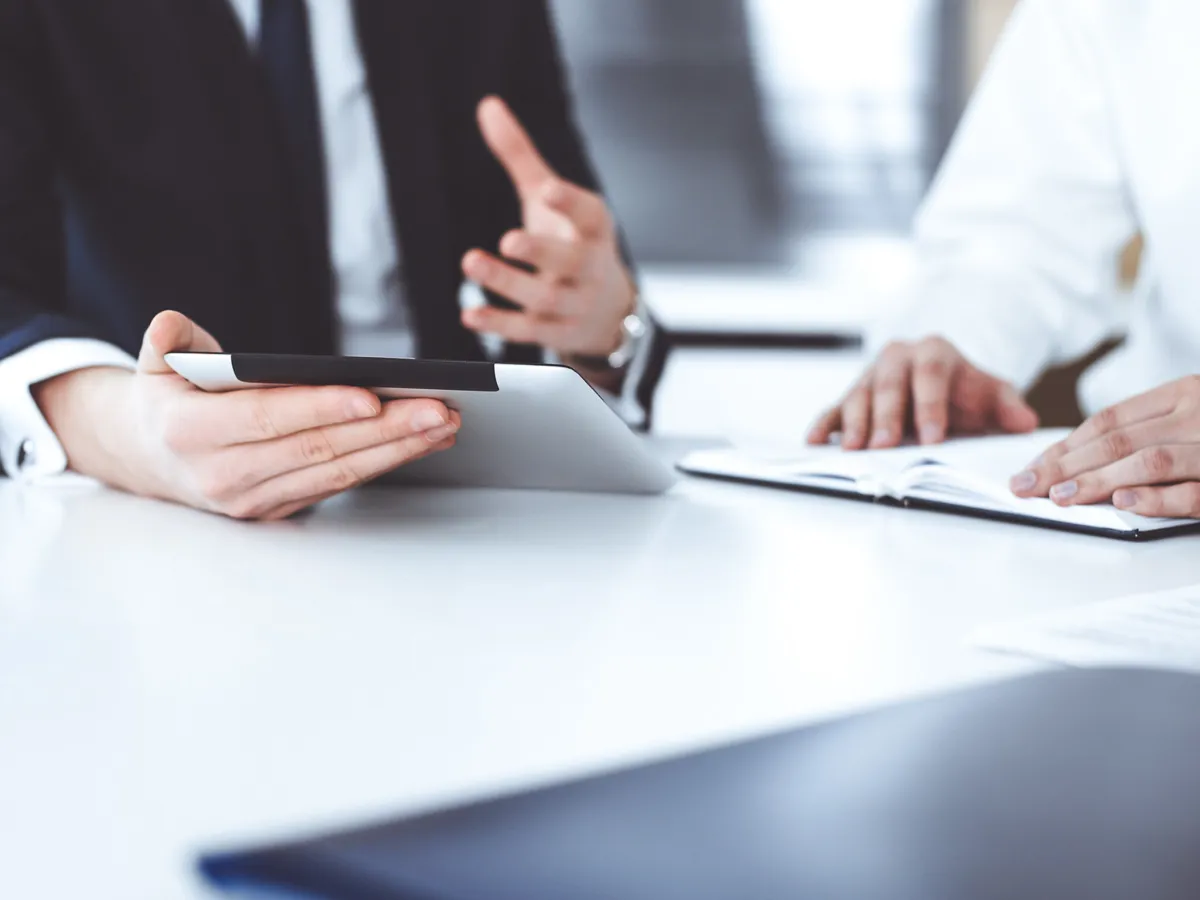 Two people discussing a document