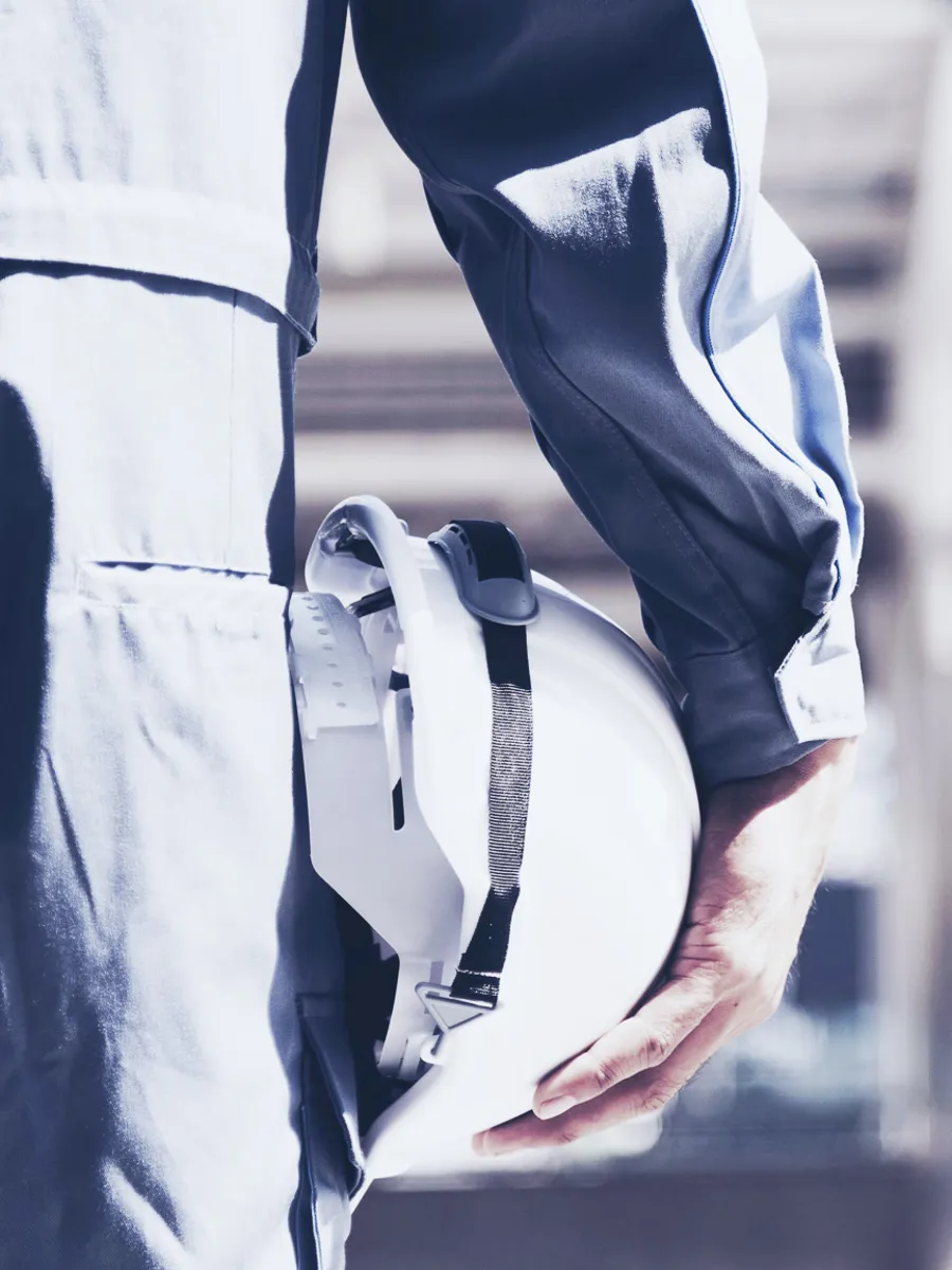 Construction worker holding a helmet