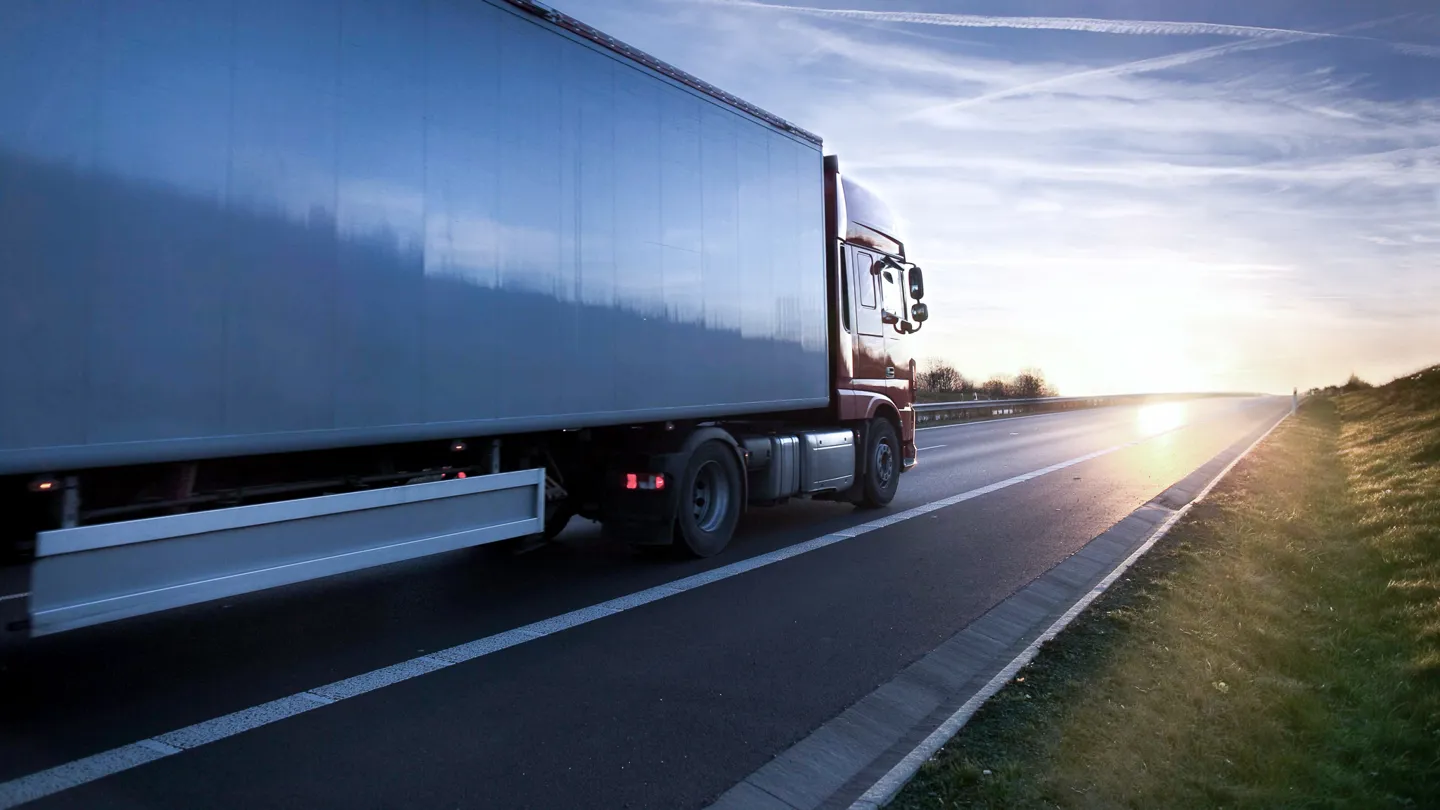 Truck on highway in sunset