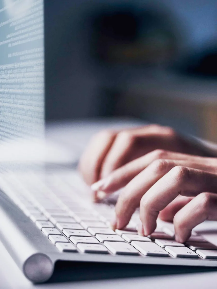 Hands typing on keyboard