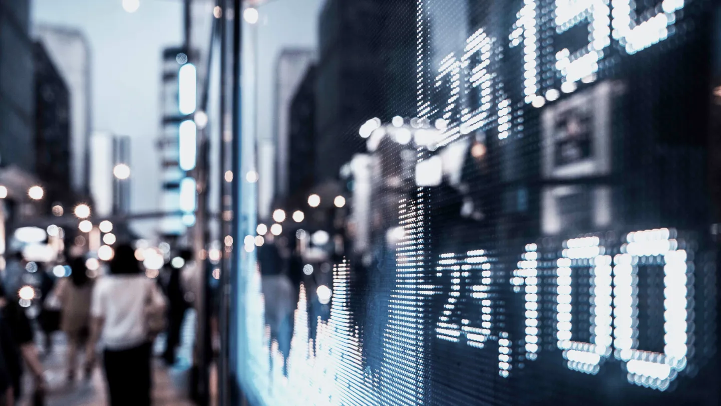 Numbers and charts on screen in big city